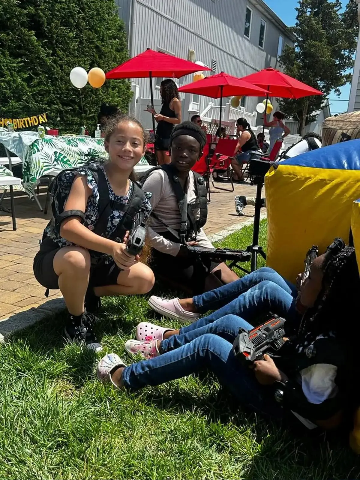 Kids crouching with laser tag blasters mid-game